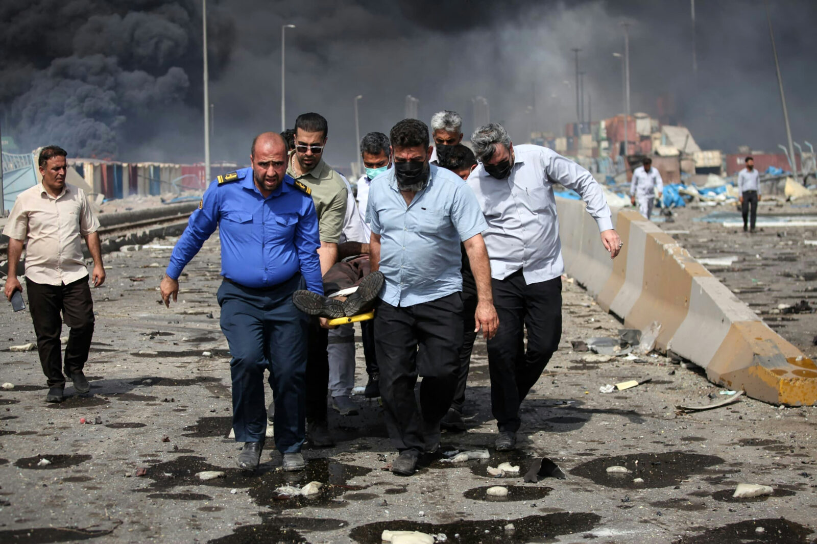 People transport an injured man along a devastated boulevard following an explosion at the Shahid Rajaee port dock southwest of Bandar Abbas in the Iranian province of Hormozgan, Iran on April 26, 2025. (AFP Photo)