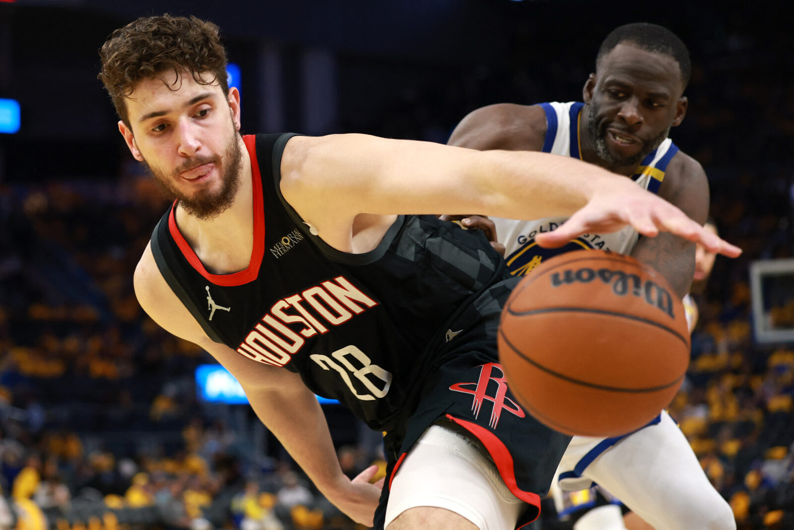Alperen Sengun #28 of the Houston Rockets and Draymond Green #23 of the Golden State Warriors vie for a loose ball during the third quarter in Game Three of the Western Conference First Round NBA Playoffs at Chase Center on April 26, 2025 in San Francisco, California. (AFP Photo)