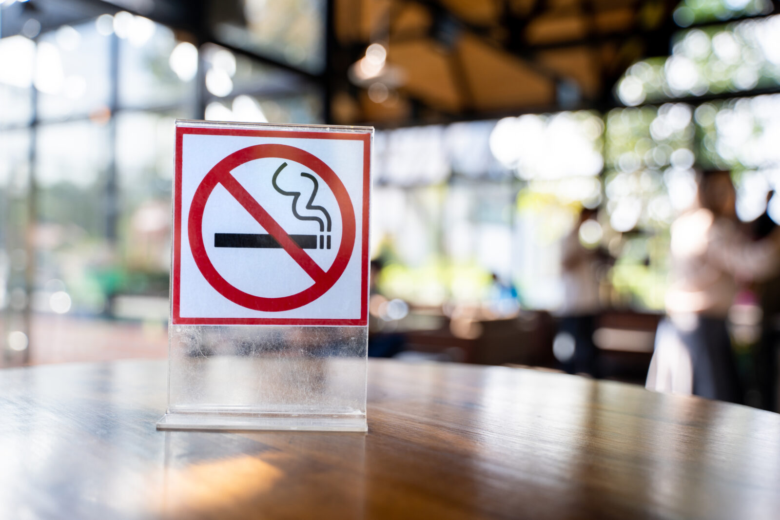 A “No Smoking” sign on a table in a cafe. (Adobe Stock Photo)