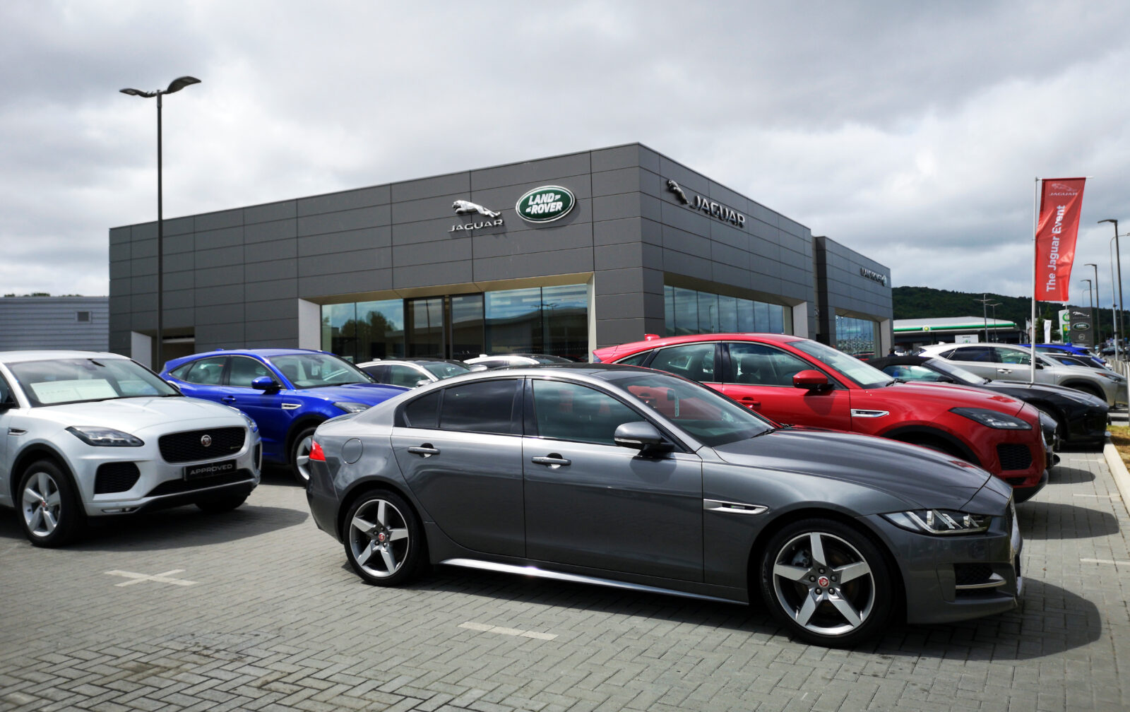 A Jaguar dealership displays a lineup of luxury vehicles, including the Jaguar XJ sedan in the foreground in Cardiff, UK, on Jul. 20, 2019. (Adobe Stock Photo)
