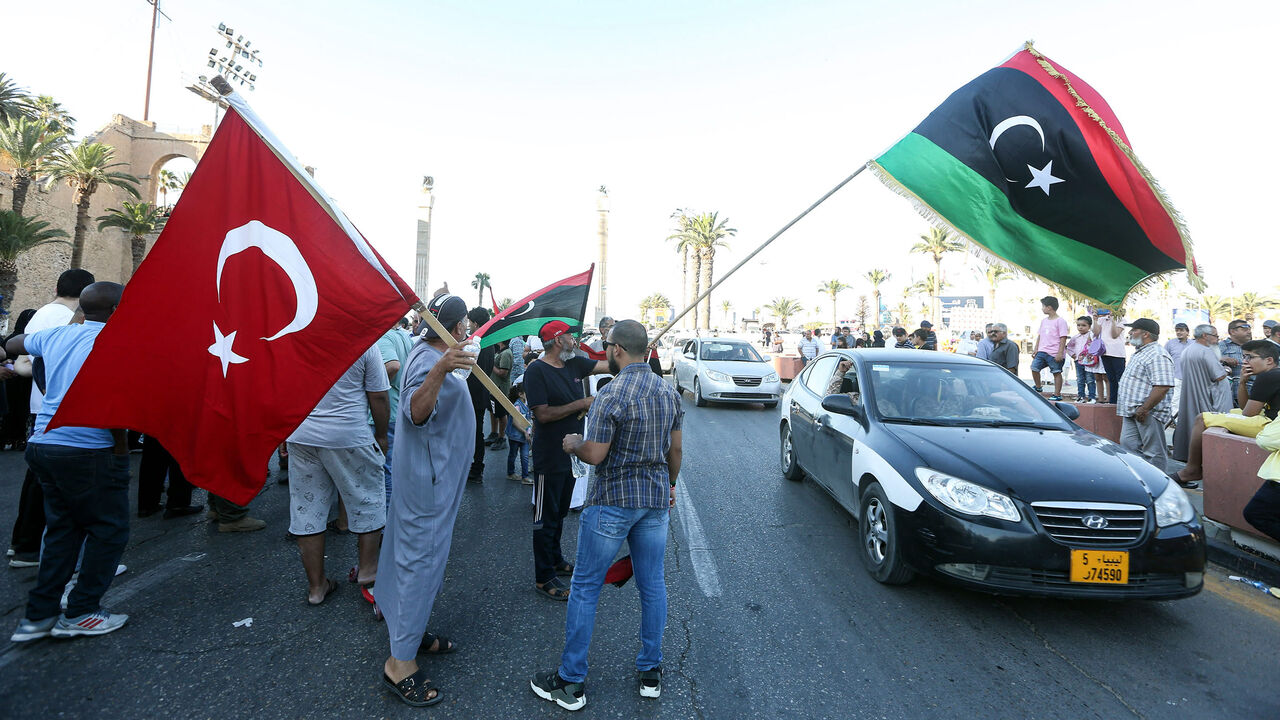 People wave flags of Libya (R) and Türkiye (L) during a demonstration in Martyrs' Square in the center of the Libyan capital, Tripoli, June 21, 2020. (AFP Photo)