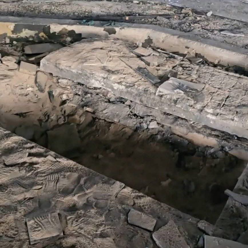 The desecrated tomb of former Syrian dictator Hafez al-Assad in Qardaha shows an empty grave pit surrounded by broken stone and debris following reports of exhumation, accessed on April 29, 2025. (Photo via X/@SonjaEnde)