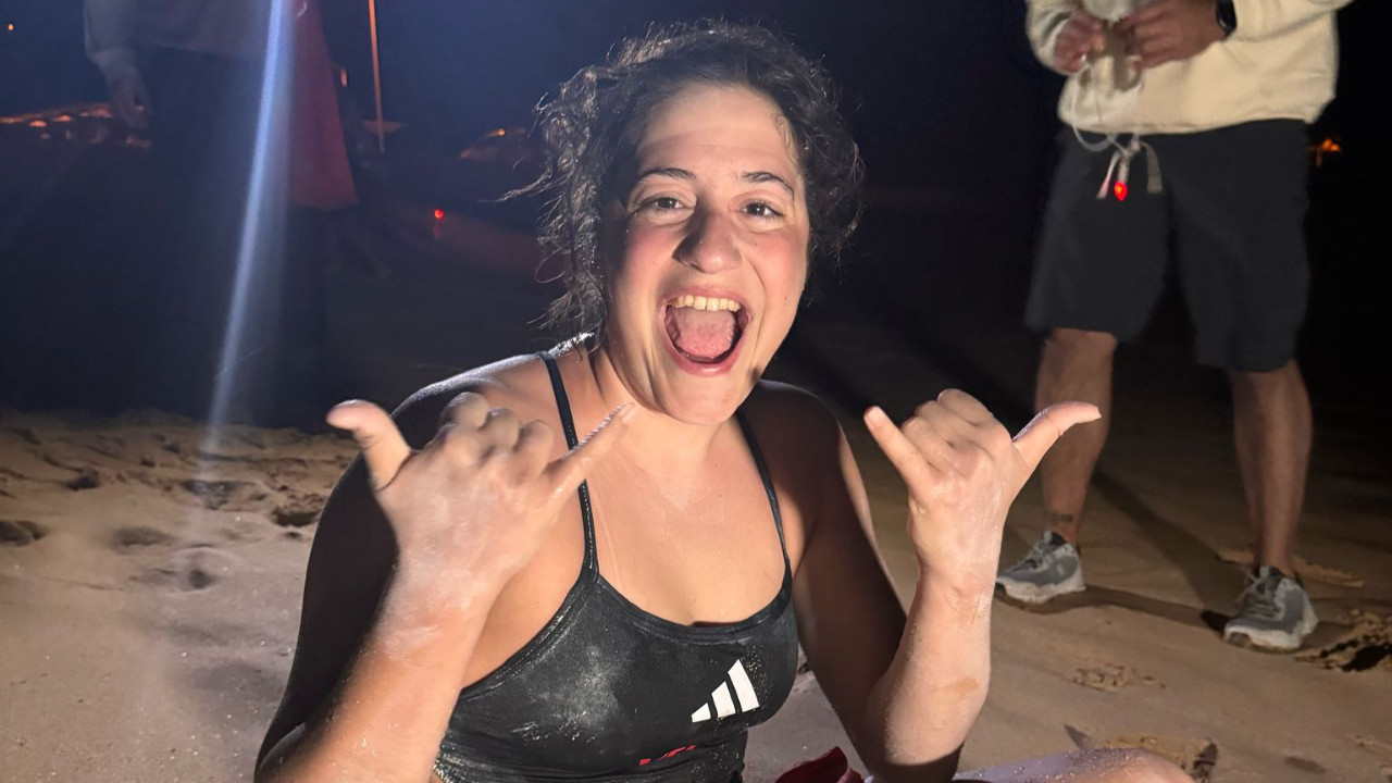 Open water swimmer Aysu Turkoglu, sponsored by Vestel, celebrates her victory after completing the fifth leg of the 