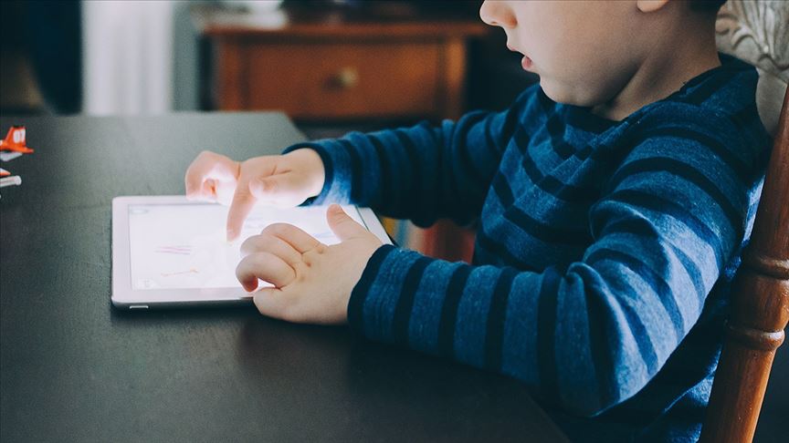 File photo shows a Turkish child using a tablet at home, accessed on April 19, 2025. (AA Photo)