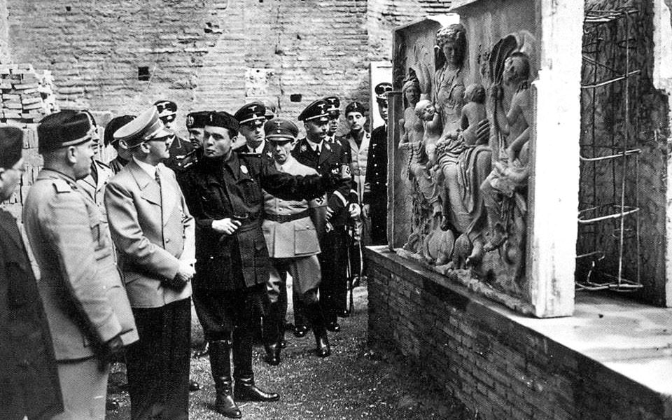A photograph of Adolf Hitler while walking inside the Coliseum