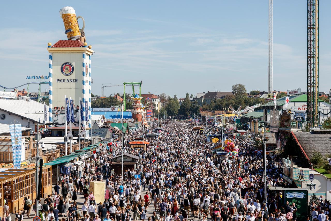 Visitors walk at the Theresienwiese fairground during the 190th Oktoberfest beer festival in Munich, southern Germany on Sept. 21, 2025. (AFP Photo)