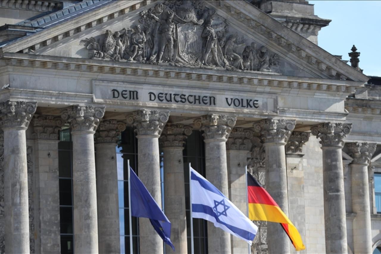 Flags of Germany, Israel and the EU are seen outside the German lower house of parliament Bundestag in Berlin, Germany. (AA Photo)