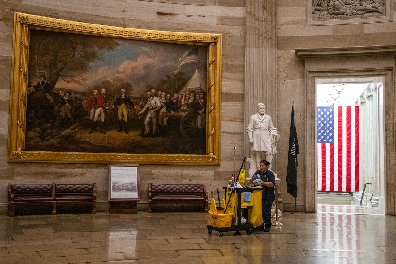 A member of the cleaning staff makes her way through the Rotunda on an empty U.S. Capitol hours before a partial government shutdown is set to take effect in Washington, U.S. on Sept. 30, 2025. (AFP Photo)