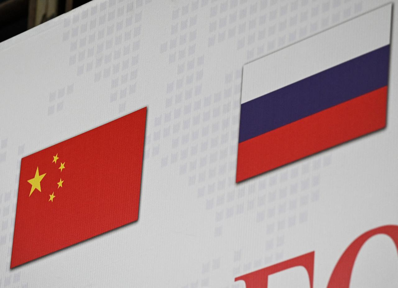 The Chinese and Russian national flags (R) are seen on the international logistics billboard in Ritan International Trade Center in Beijing on March 22, 2022. (AFP Photo)