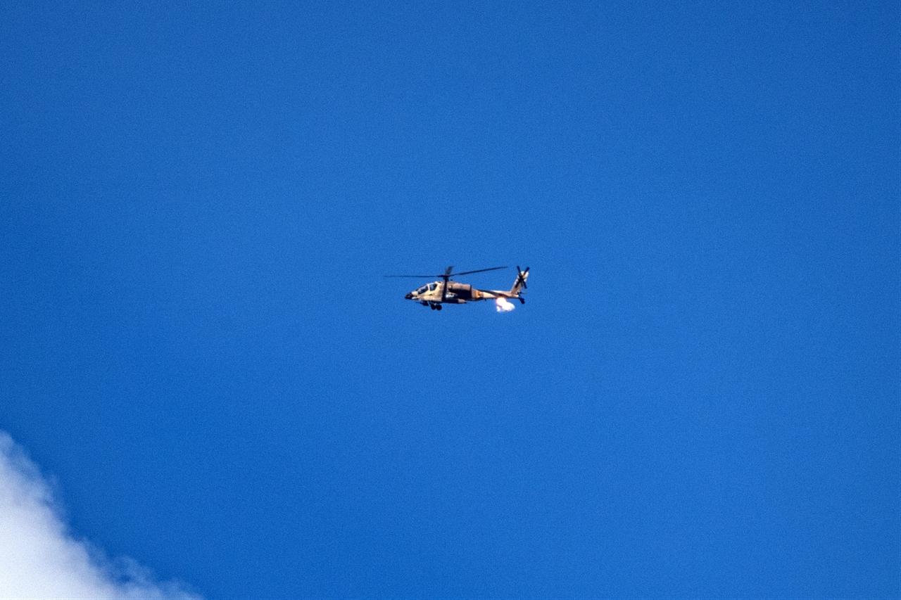 An Israeli helicopter flies over the Gaza Strip, as seen from the Israeli city of Sderot near the border, on October 10, 2025. (AA Photo)