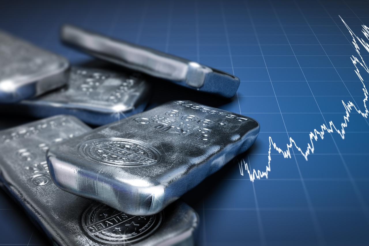 Silver bars pictured against a financial chart showing a strong upward trend in global silver prices. (Adobe Stock Photo)