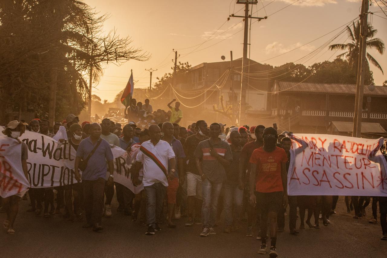 Protesters carry banners as they march during a protest calling for constitutional reforms and the resignation of President Andry Rajoelina in Antsiranana on October 10, 2025. (AFP Photo)