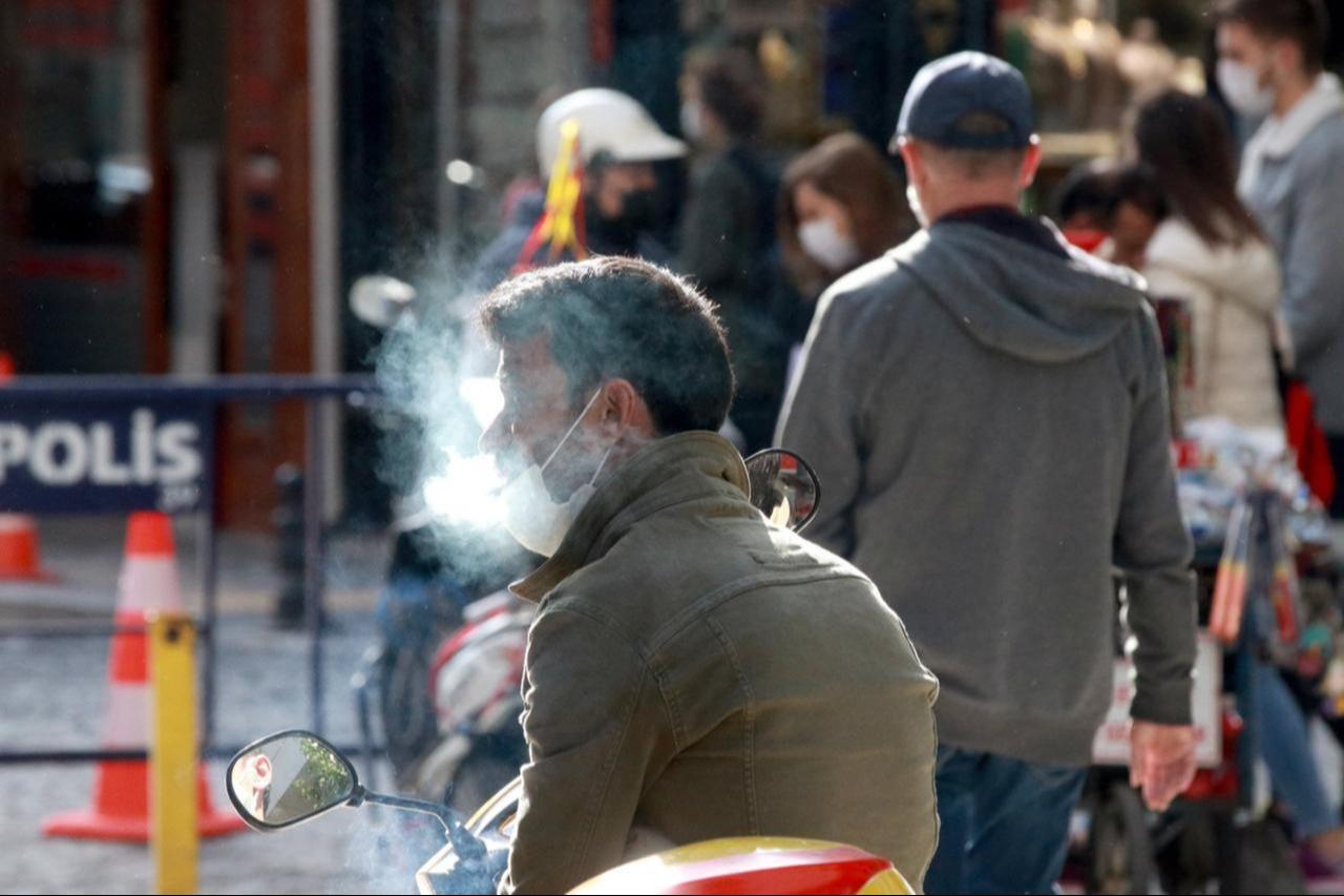 A man smokes a cigarette with his mask down in Kirklareli, Türkiye, November 13, 2020. (AA Photo)
