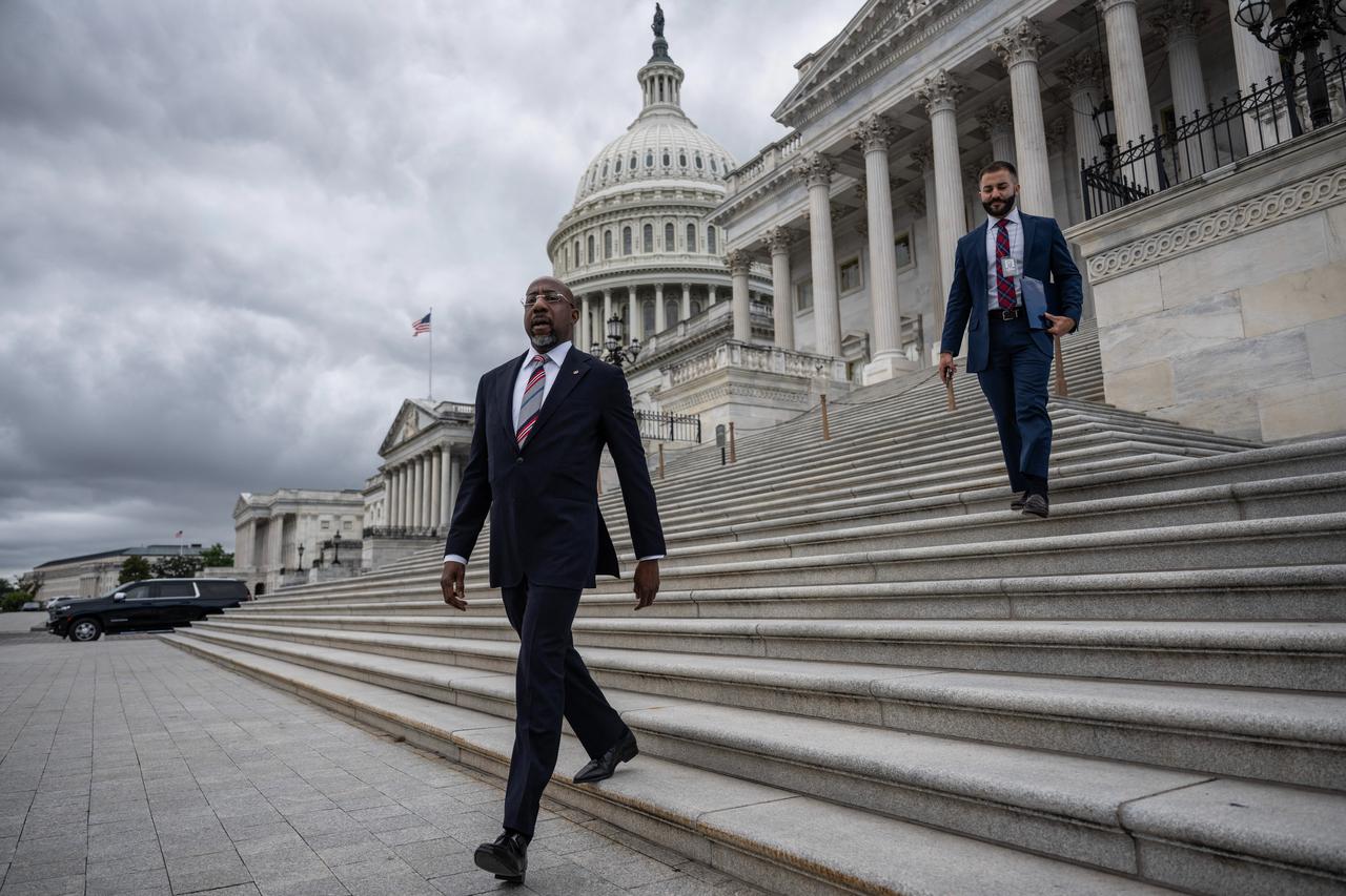 U.S. Senator Raphael Warnock, Democrat of Georgia, leaves the US Capitol on the 8th day of the US government shutdown, Washington, on Oct. 8, 2025. (AFP Photo)