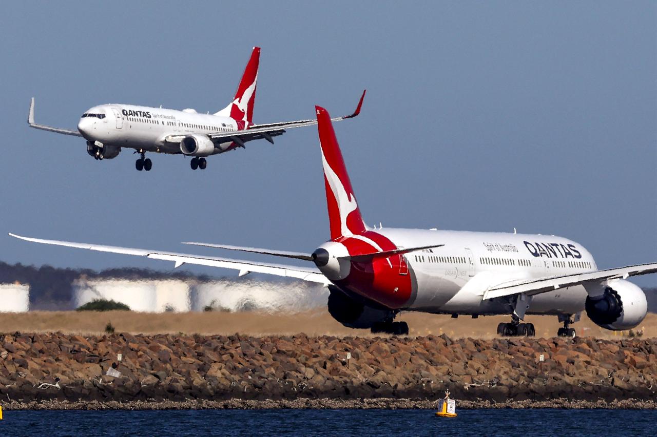 This photo taken on September 4, 2024 shows a Qantas Boeing 737-800 plane (L) coming in to land next to a Qantas Boeing 787 Dreamliner aircraft preparing to take-off at Sydney International Airport. (AFP File Photo)