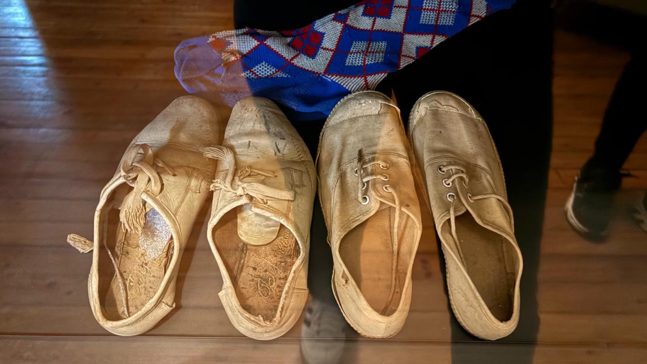 Canvas shoes and a child’s knitted sock from the Ilhan family, kept as part of the personal belongings exhibited at the Museum of Barbarism, Lefkosa, TRNC, Oct. 10, 2025. (IHA Photo)