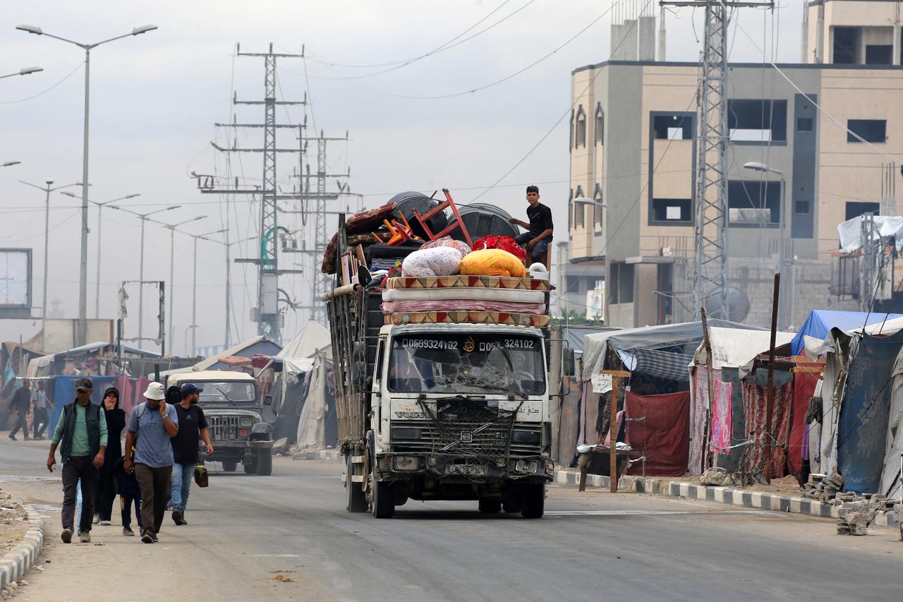 Displaced Palestinians returning to Gaza City, drive by tents used as temporary shelters in the Nuseirat refugee camp in the central Gaza Strip, on Oct. 12, 2025. (AFP Photo)