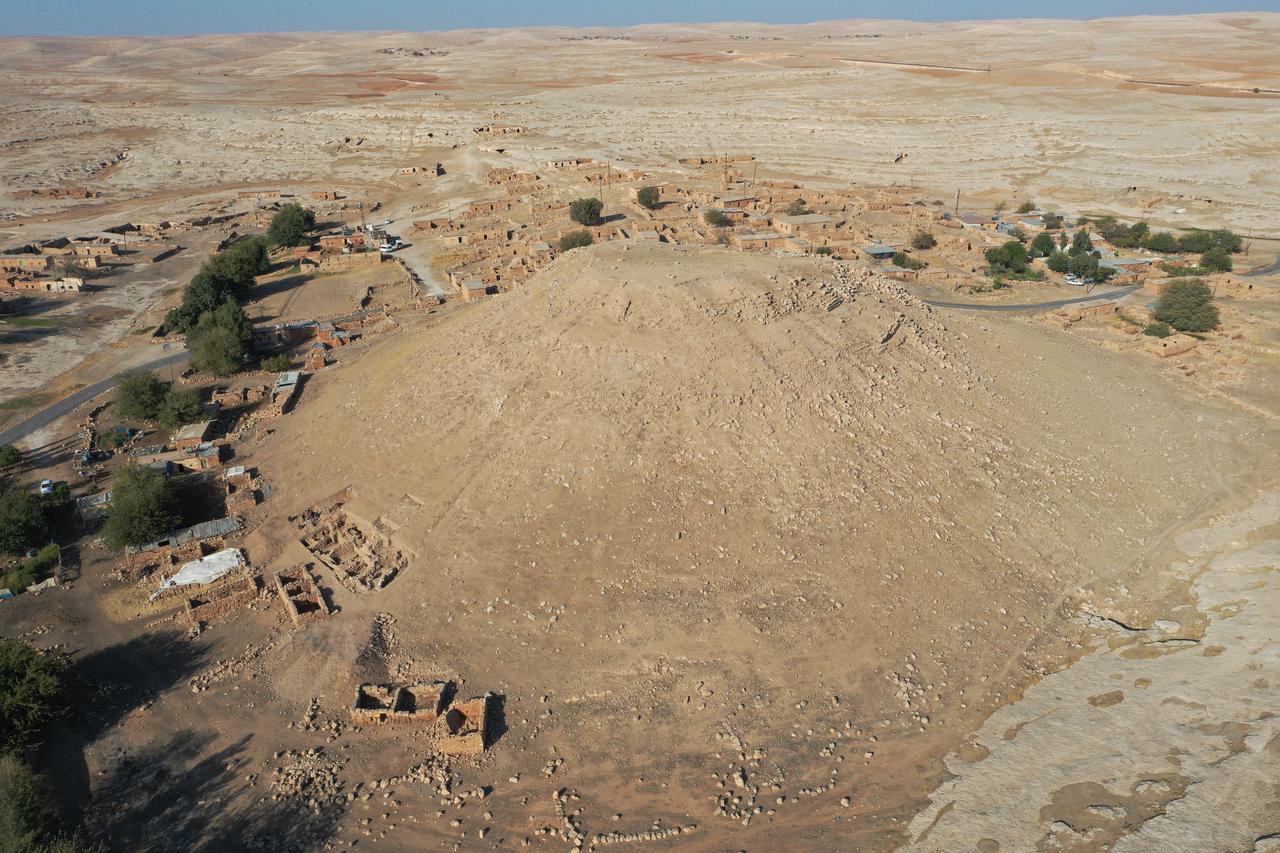 An aerial view shows the mound and excavation areas where Iron Age remains were unearthed at ancient city of Sogmatar in Sanliurfa, Türkiye, Oct. 12, 2025. (AA Photo)