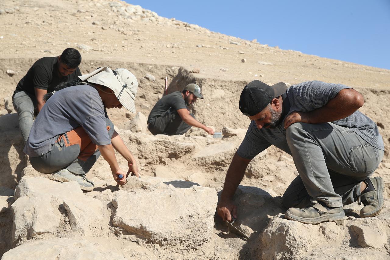Excavation team members work to expose Iron Age structures at ancient city of Sogmatar, believed to date back around 3,000 years, in Sanliurfa, Türkiye, Oct. 12, 2025. (AA Photo)