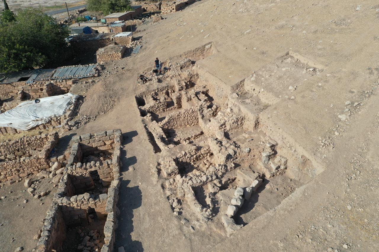 An aerial view shows the mound and excavation areas where Iron Age remains were unearthed at ancient city of Sogmatar in Sanliurfa, Türkiye, Oct. 12, 2025. (AA Photo)
