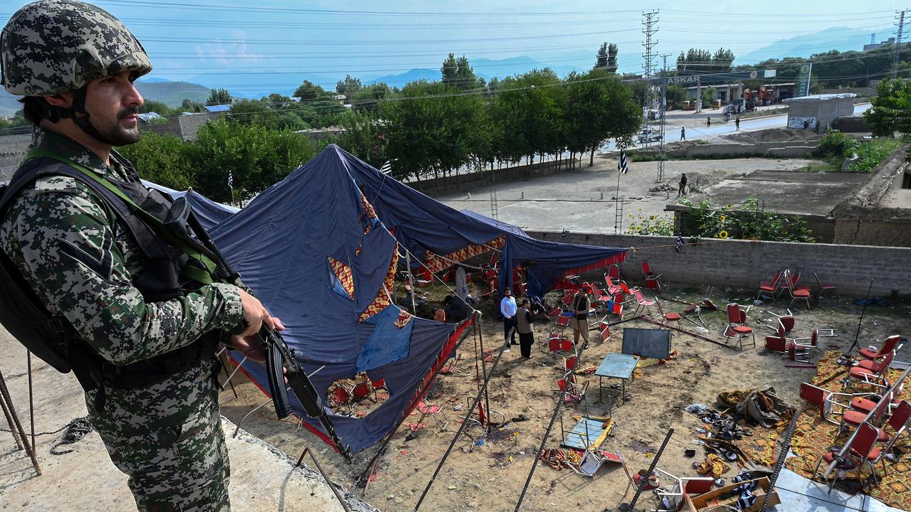 Security personnel stand guard next to the site of a bomb blast in Bajaur district of Khyber-Pakhtunkhwa province on July 31, 2023. (AFP Photo)