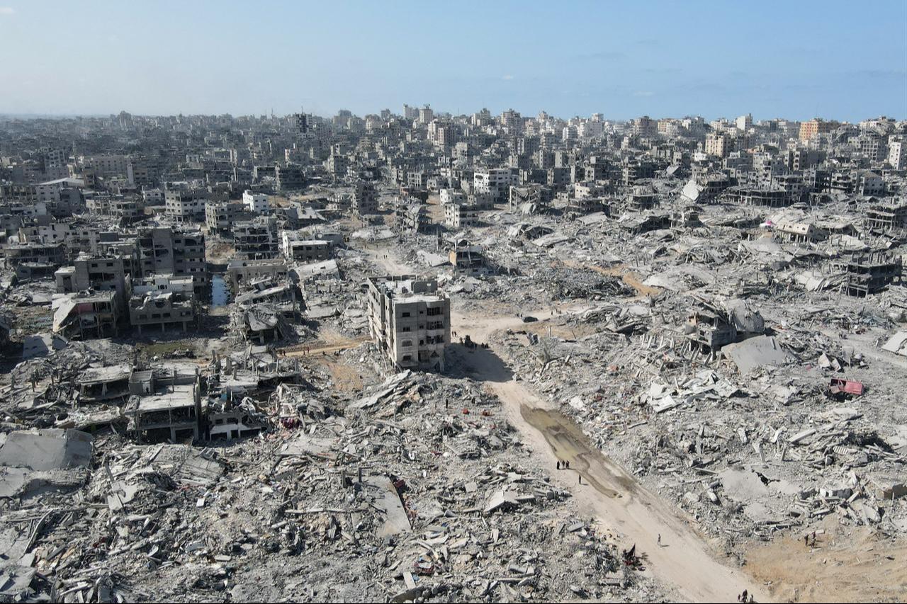 In this aerial view, people walk amid the destruction in Gaza City in the northern Gaza Strip on October 11, 2025. (AFP Photo)