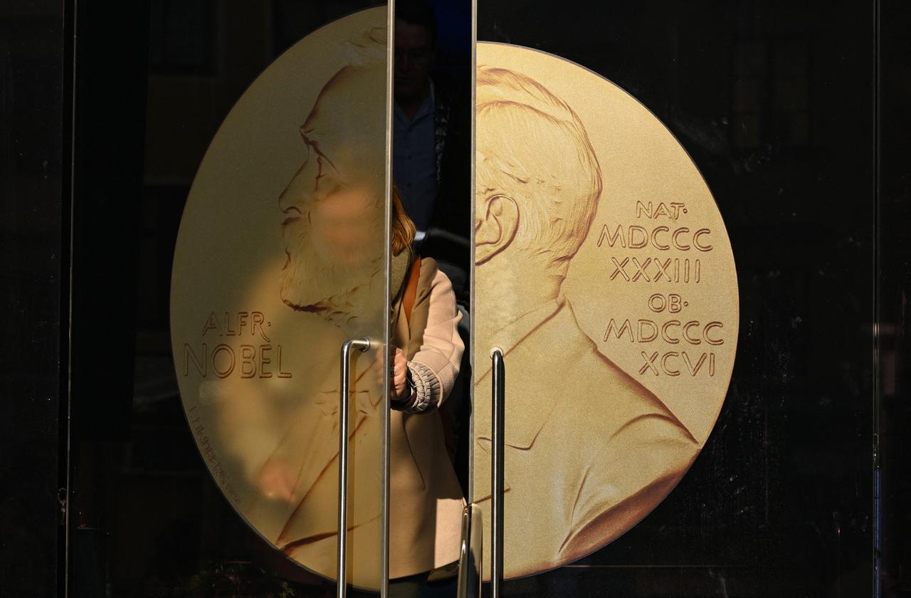 A person opens the door to leave the Swedish Academy ahead of the 2025 Nobel Prize in Literature at the Swedish Academy in Stockholm, Sweden, on October 9, 2025. (AFP Photo)