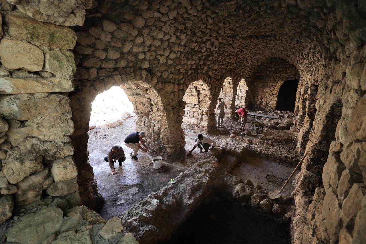 Archaeologists clean sections of a 1,500-year-old mosaic floor uncovered beneath a historic water mill in Midyat, Mardin, southeastern Türkiye, Oct. 14, 2025. (AA Photo)