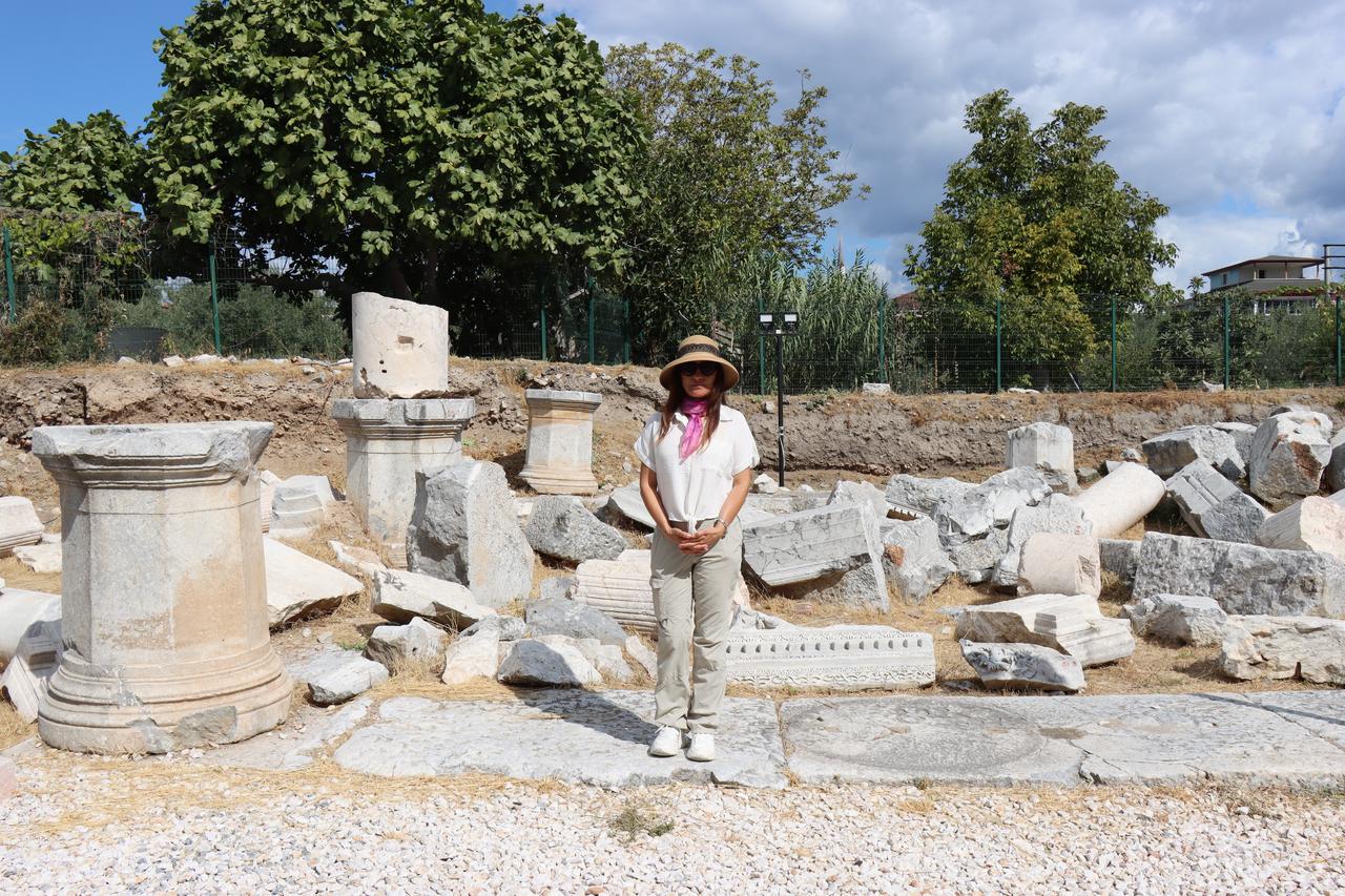 Lead archaeologist Professor Aygun Ekin Meric stands among marble fragments and column bases unearthed at the ancient Roman theater of Nicaea (modern-day Iznik) in Türkiye’s Bursa province, Oct. 13, 2025. (AA Photo)