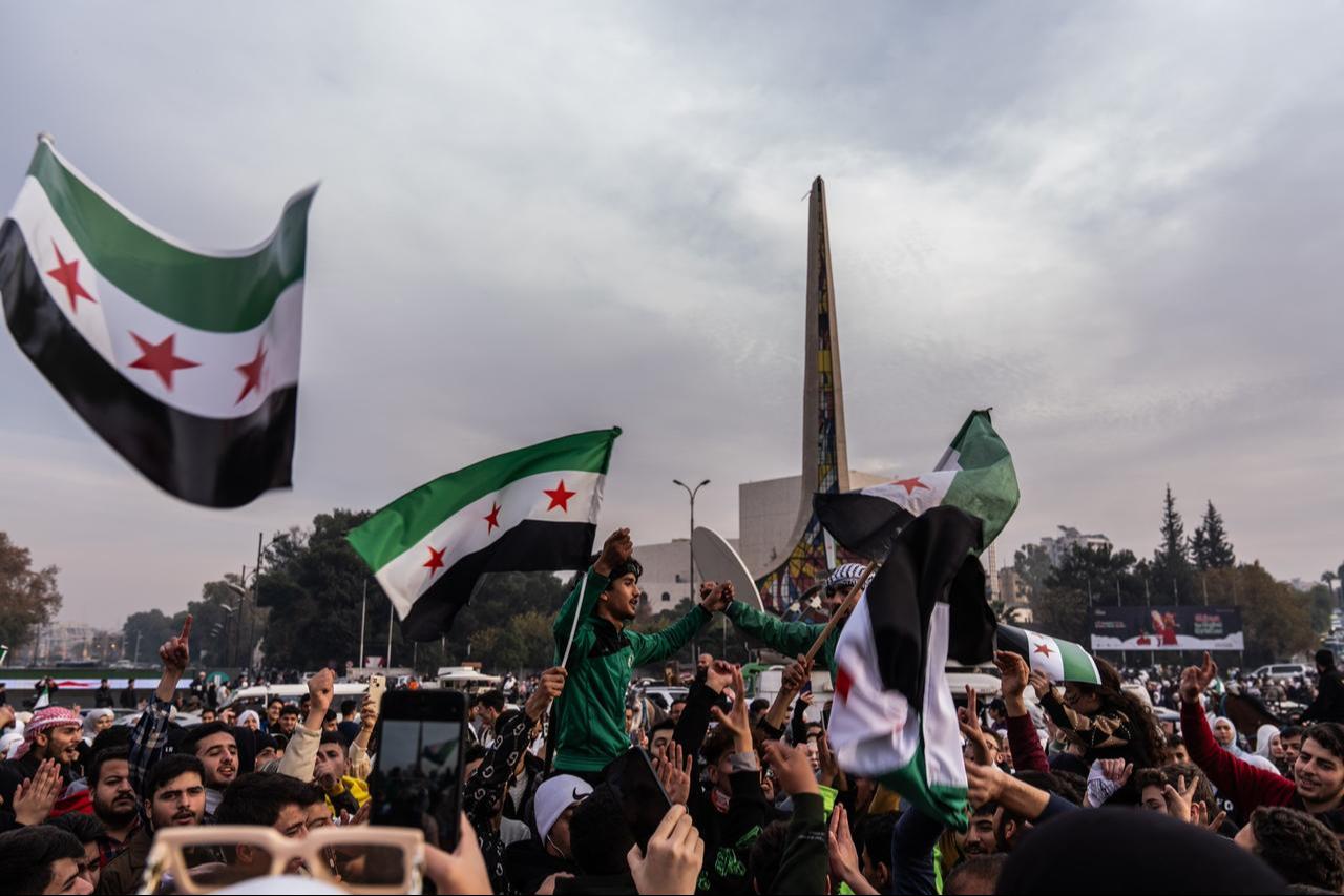 Syrians waving flags gather at Umayyad Square to celebrate the collapse of the 61-year Baath regime, in Damascus, Syria on December 11, 2024. (AA Photo)