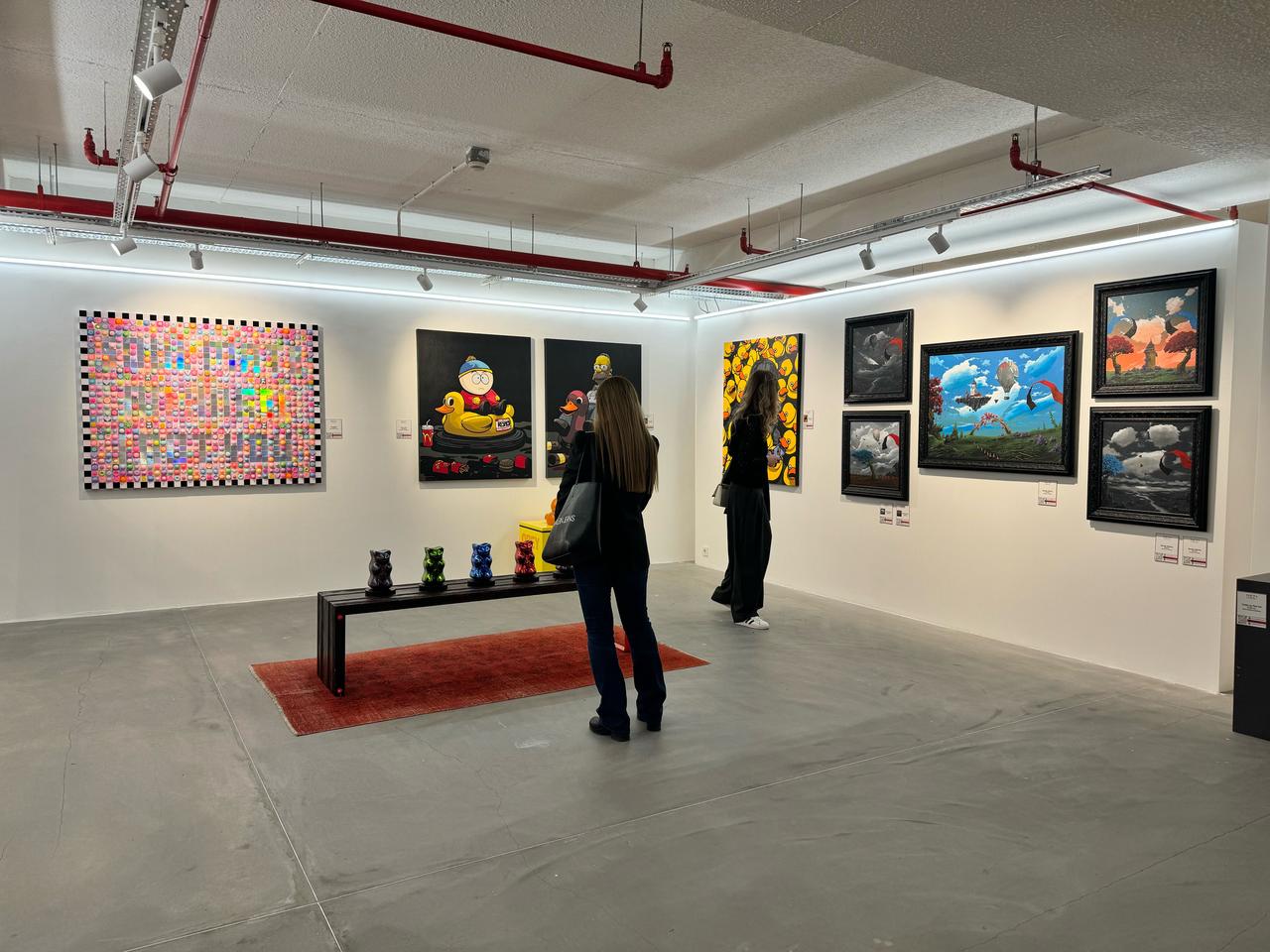 Art enthusiasts examine pieces on display during the opening of Artweeks Istanbul, which brings together galleries, artists, and institutions from across Türkiye, Oct. 15, 2025. (AA Photo)