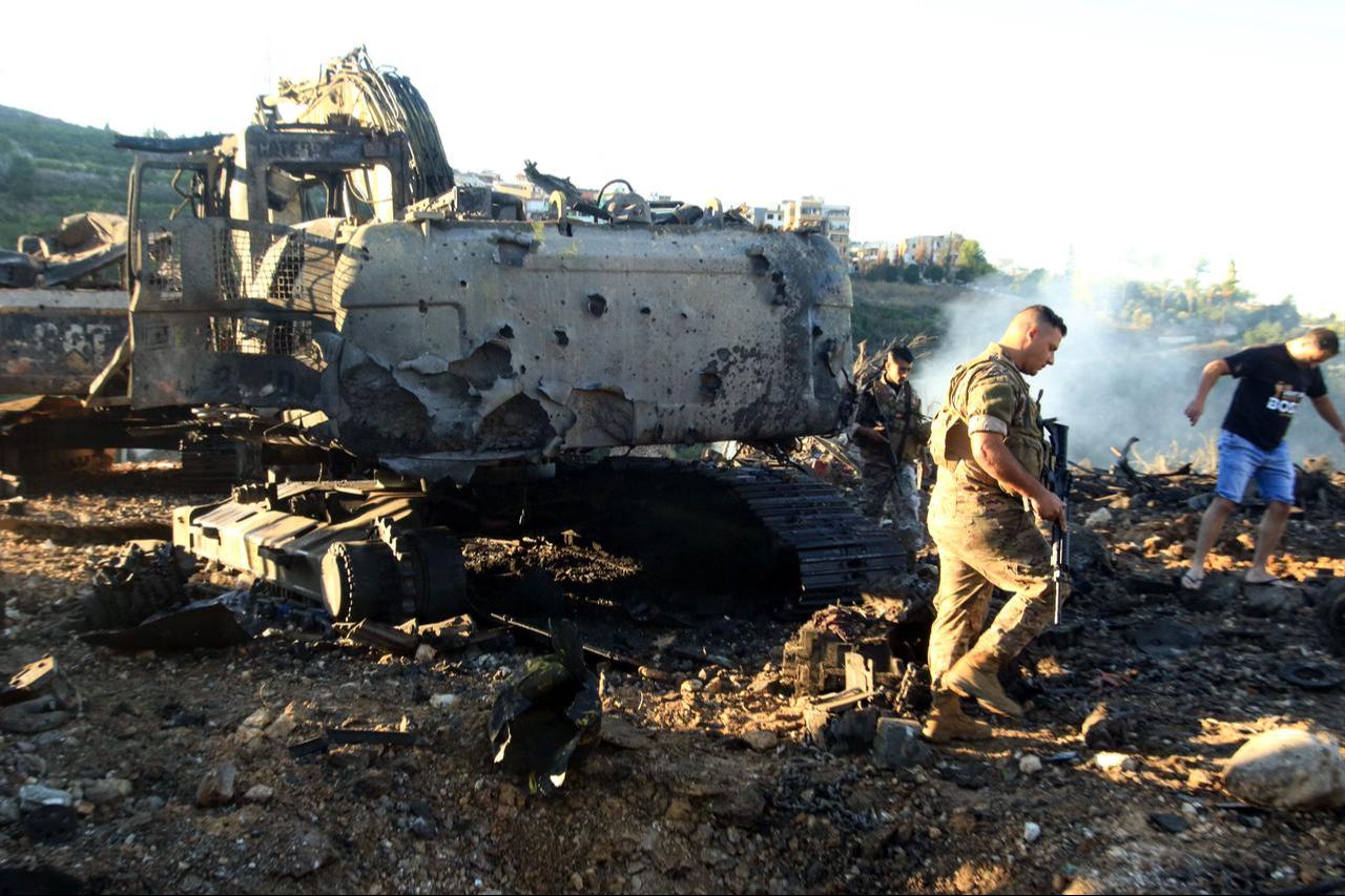 Lebanese soldiers walk next to a destroyed digger following an overnight Israeli strike in Al-Msayleh area in southern Lebanon on October 11, 2025. (AFP Photo)