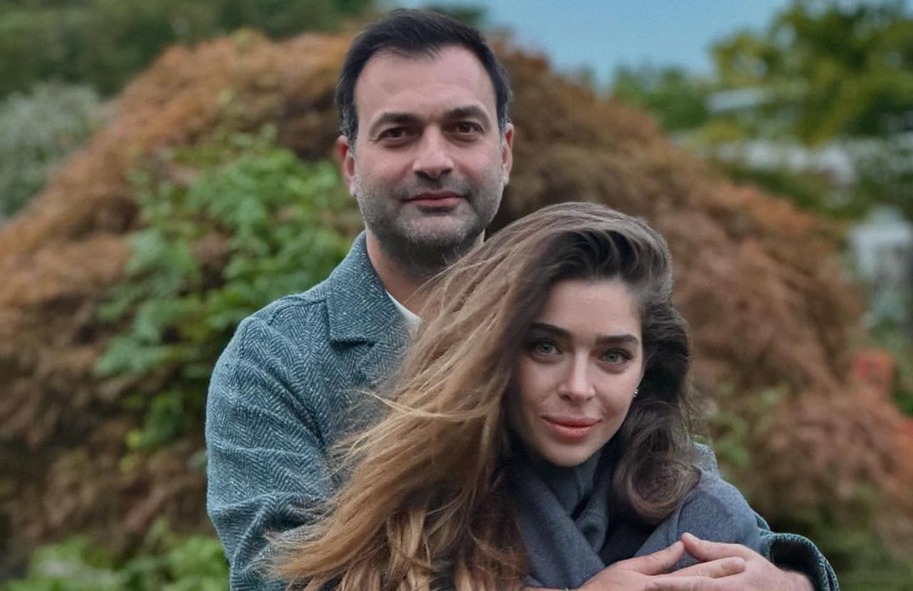 Oyku Celik and Ali Cakici pose outdoors in a natural setting, sharing a moment together. (Photo via Instagram/@oykucelikk_)