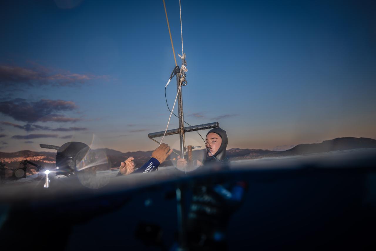 World record holder Sahika Ercumen and safety divers conduct depth-line checks at sunrise before her freediving training in Kas, Antalya, Türkiye, Oct. 16, 2025. (AA Photo)