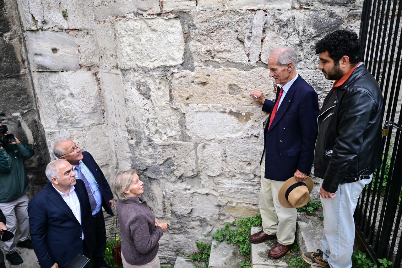 Count Nikolai Tolstoy examines the stone walls of the Yedikule Fortress as his wife and accompanying officials look on during their tour of the historic site in Istanbul, Türkiye, Oct. 16, 2025. (AA Photo)