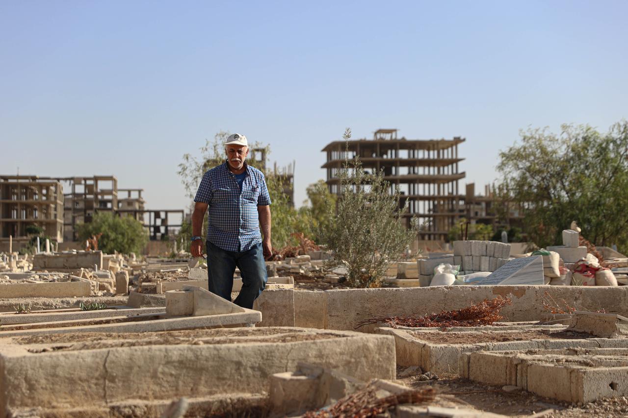 Nael Hamid Abu Yaser, Head of Yarmouk Camp Cemeteries, is seen Yarmouk cemetery with damaged tombstones during an exclusive interview in Damascus, Syria on Sept. 23, 2025. (AA Photo)