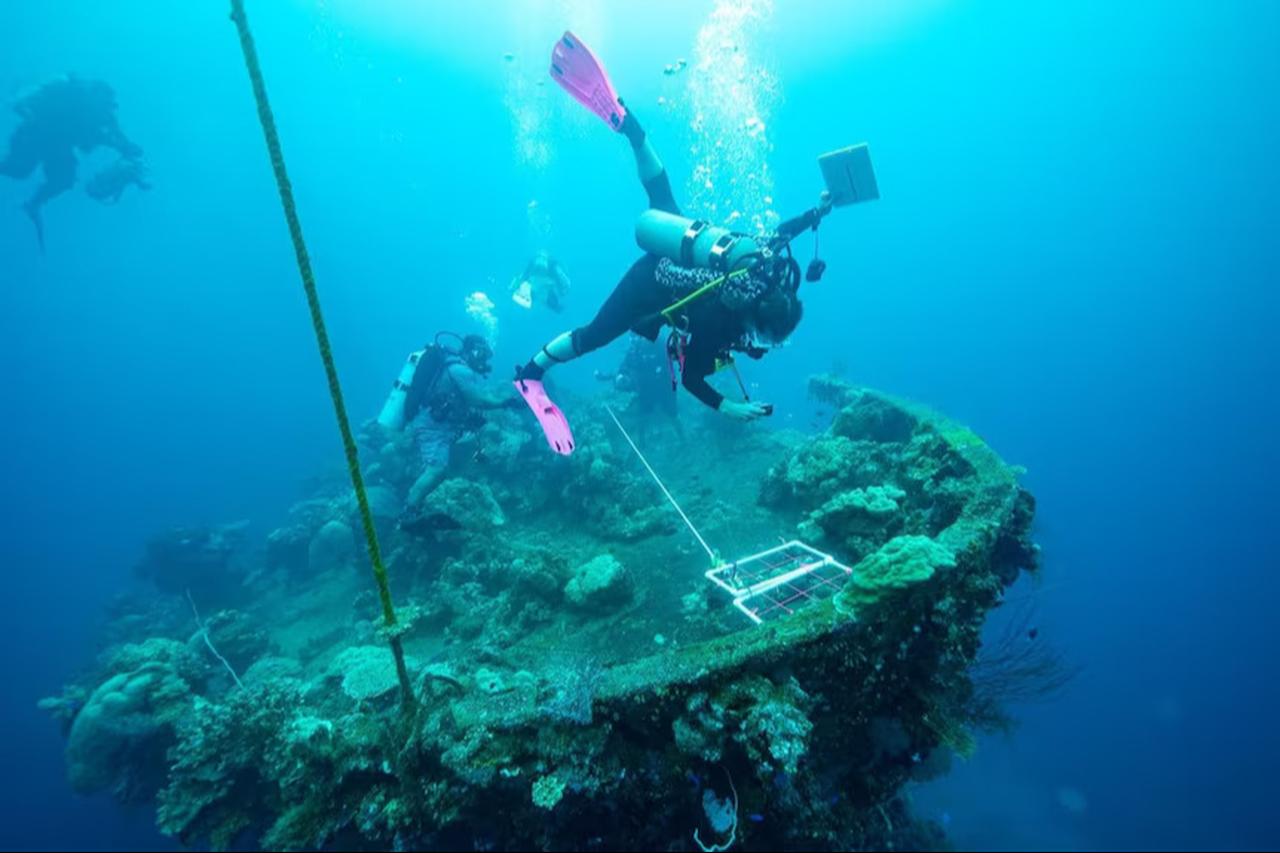 Scuba divers examine the remains of a Japanese vessel destroyed during World War II in Chuuk Lagoon. (Photo via Ranger Walter)