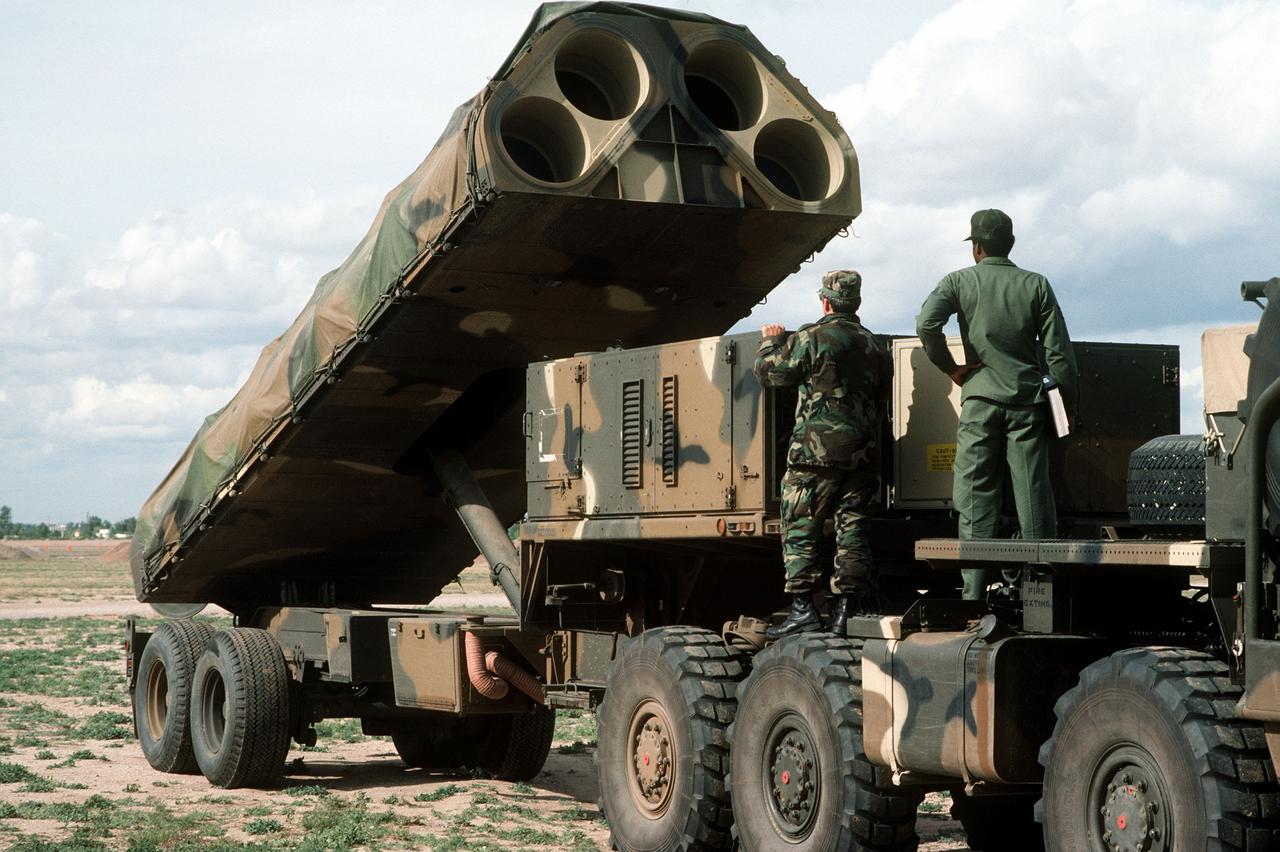 Members of the 487th Tactical Missile Wing (TMW) raise the launch tubes of a Ground Launch Cruise Missile (GLCM) launcher during a field training deployment, accessed on Nov. 18, 1983. (Photo via USAF)