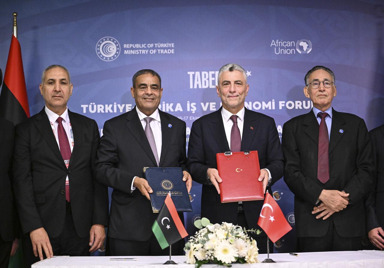 Turkish Trade Minister Omer Bolat (second right) poses for a photo with Libyan Economy and Trade Minister Muhammad al-Huwayj (second left) and Libyan Transport Minister Muhammad Salem Al-Shahoubi (right) after signing new cooperation agreements during the 5th Türkiye-Africa Business and Economic Forum in Istanbul, Türkiye, October 16, 2025. (AA Photo)