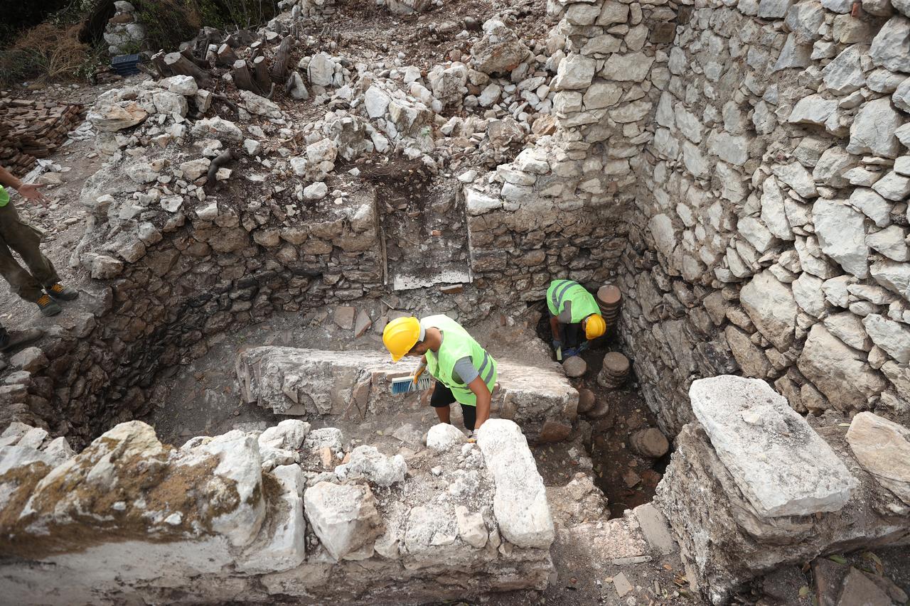 2 Ekim 2025, Antalya, Türkiye'deki Olympos Antik Şehrinde yeni keşfedilen hamamın hipokost ısıtma sistemini belgeleyen arkeologlar. (AA Photo)