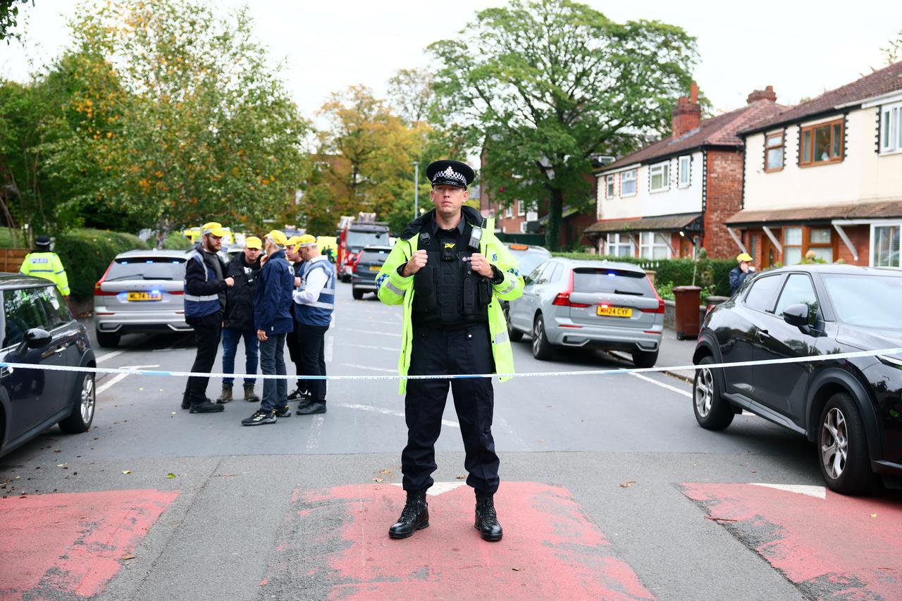 A Police officer stands on duty at a cordon near Heaton Park Hebrew Congregation synagogue following reports of a stabbing in Crumpsall, north Manchester, on Oct. 2, 2025. (AFP Photo)