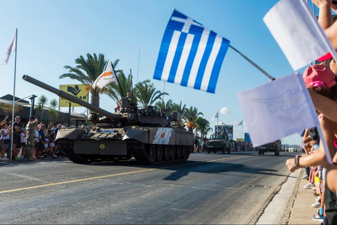 People watch as soldiers in a tank take part in a military parade in Nicosia on October 1, 2025. (AFP Photo)
