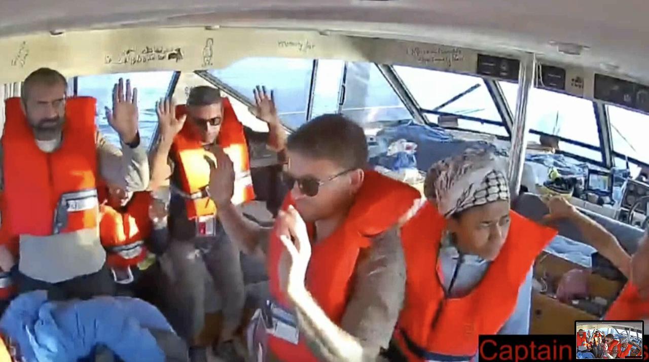 A screen grab shows activists aboard a Global Sumud Flotilla vessel raising their hands to prove they were unarmed in Mediterranean Sea, Oct. 02, 2025. (Photo via Global Sumud Flotilla)