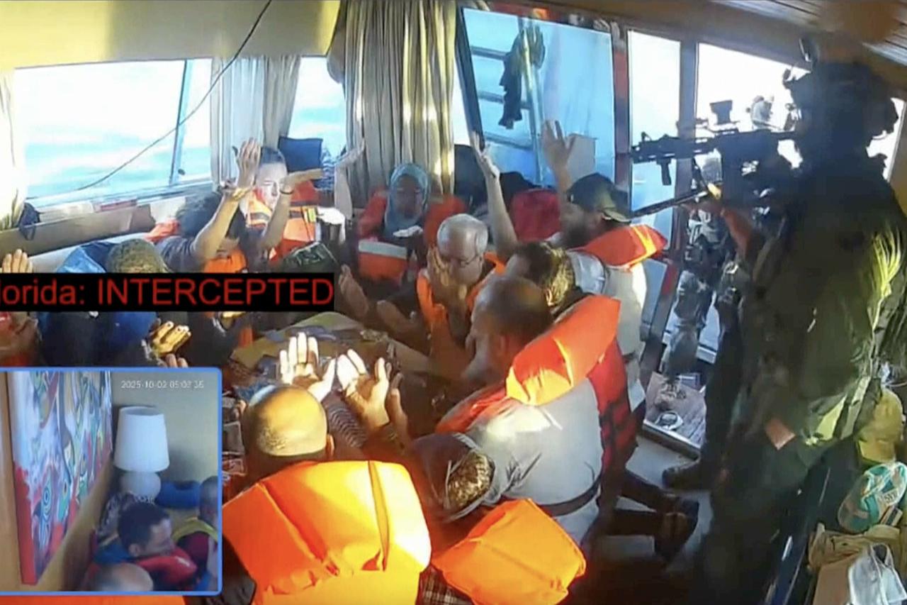 A screenshot shows activists aboard a Global Sumud Flotilla vessel raising their hands to prove they were unarmed in Mediterranean Sea, October 2, 2025. (Photo via Global Sumud Flotilla)