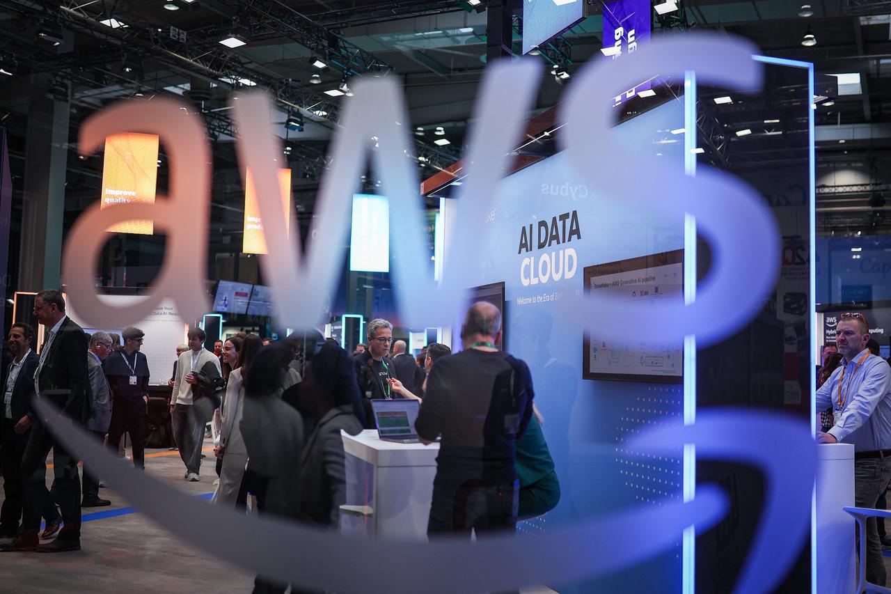 Visitors are seen at the booth of Amazon Web Services (AWS) during the opening of Hannover Messe industrial trade fair for mechanical and electrical engineering, March 31, 2025, in Hanover, Germany. (AFP Photo)