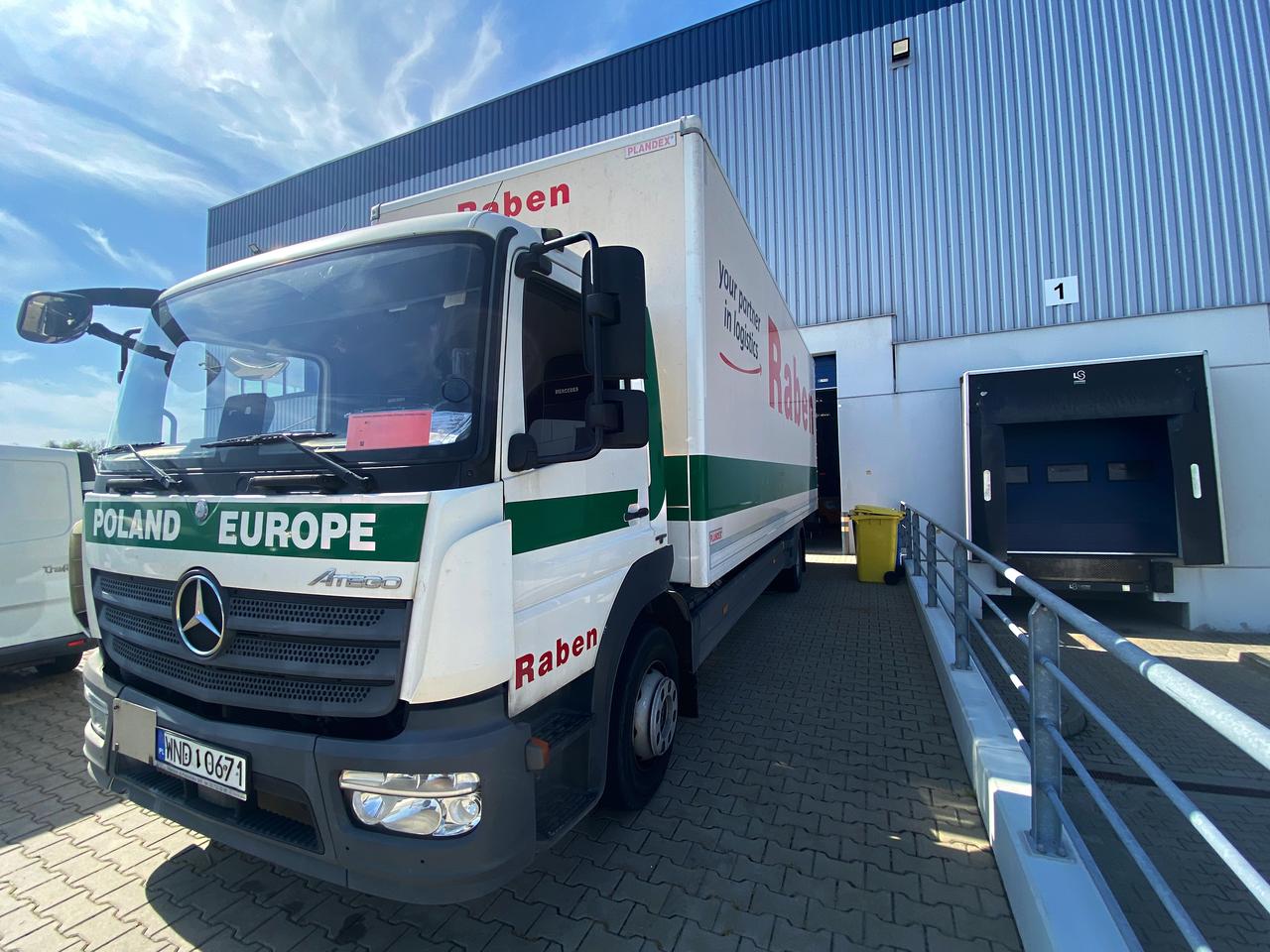 A Raben Group delivery truck loads goods at a logistics center in Poland. (Adobe Stock Photo)