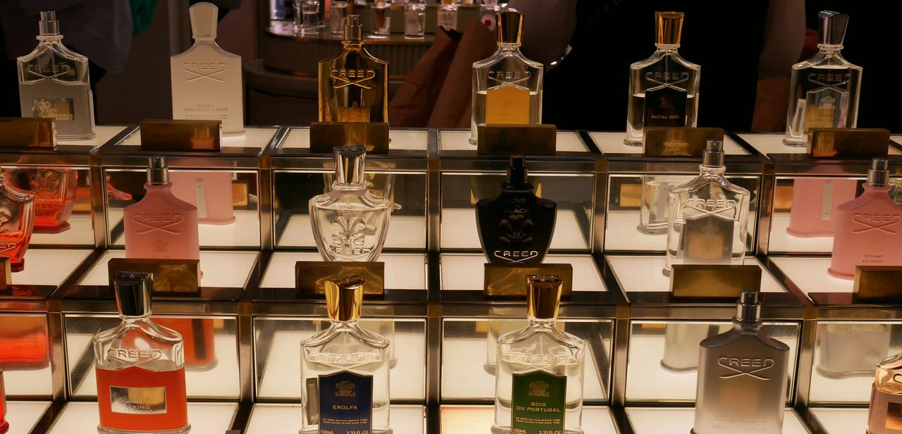 Bottles of Creed perfume are displayed at a luxury boutique. (Adobe Stock Photo)