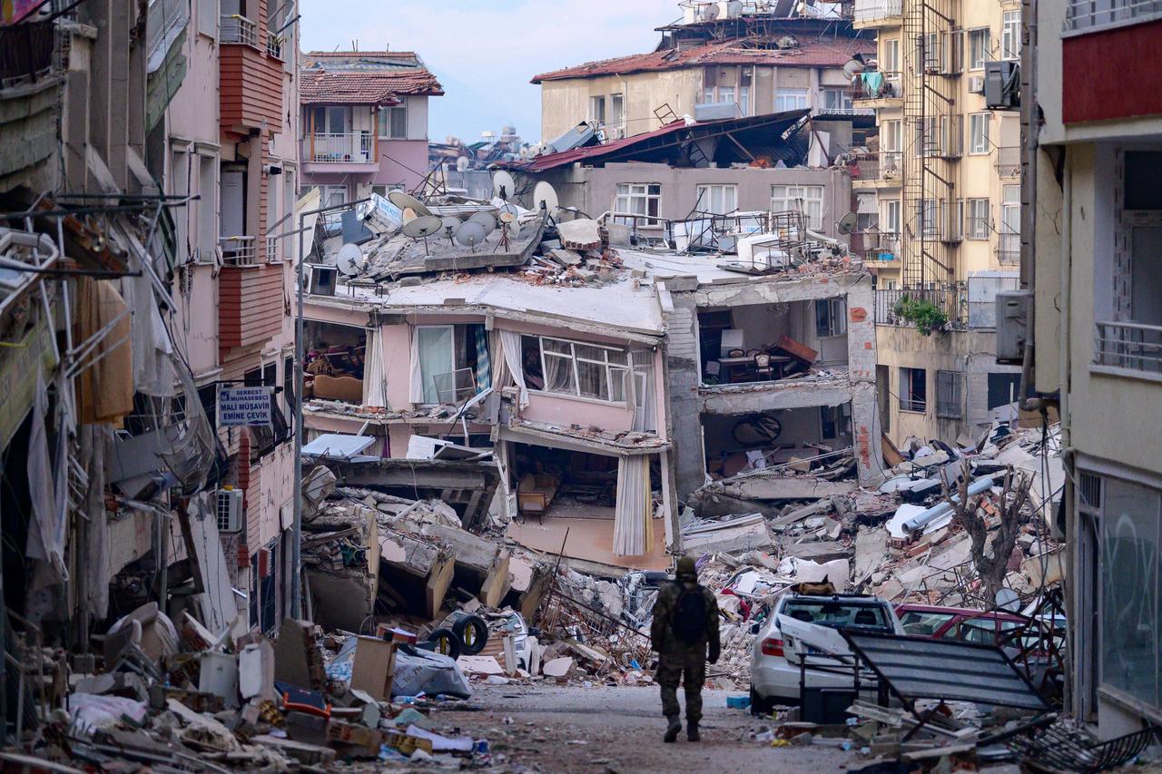 A Turkish soldier walks among destroyed buildings in Hatay, on February 12, 2023, after a 7.8-magnitude earthquake struck the countrys south-east. (AFP Photo)