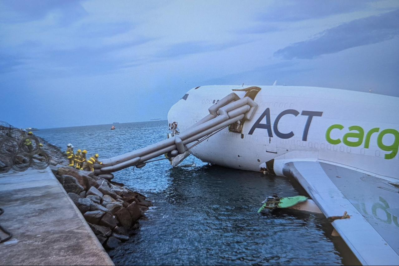 A Boeing 747-400 cargo aircraft after it hit a ground vehicle during landing on the north runway of Hong Kong's international airport and skidded into the sea, Oct. 20, 2025. (Photo by Handout/Airport Authority Hong Kong/AFP)