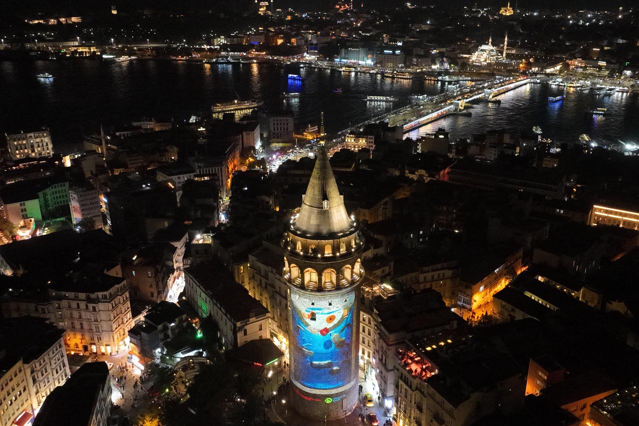 An aerial view shows environmental-themed visuals projected onto Galata Tower to highlight a sustainable future as part of Global Zero Waste Forum, Oct. 19, 2025. (AA Photo)